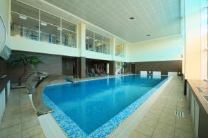 a large swimming pool in a large building at Beshtau Hotel in Pyatigorsk