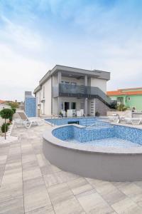 a house with a swimming pool in front of a building at LUXURY VILLA BEGANOVIC-VRH in Vrh