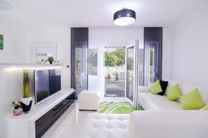 a living room with a white couch and a tv at LUXURY VILLA BEGANOVIC-VRH in Vrh