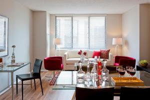 a living room with a table with wine glasses at Furnished Quarters at 15/25 Bank Street in White Plains