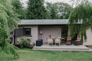 a house with a patio with a table and chairs at Lieblings Platz hytte in Kirburg