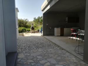 a patio with a table and chairs in a building at Apartments Antica in Šimuni