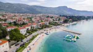 a beach in a town with boats in the water at Casteletti in Kaštela