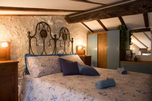 a bedroom with a bed with blue pillows on it at La Casa del Comandante in Sulzano