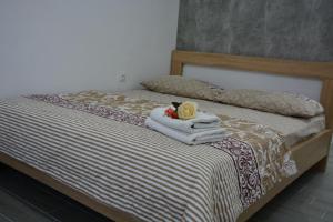 a bedroom with a bed with towels on it at Hostel Center in Ulcinj