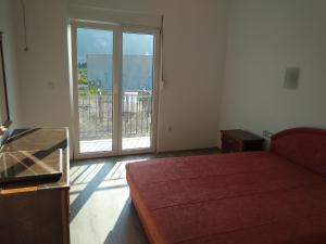 a bedroom with a bed and a sliding glass door at Vila Bella Jaz in Jaz