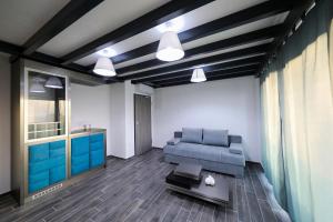a living room with a blue couch and a table at Boutique Residence Cosmopolis in Bibinje