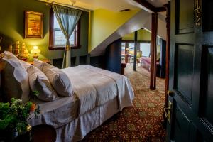 a hotel room with a bed and a staircase at The Inn at 2nd & C in Eureka