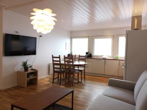 a living room with a table and a dining room at Tórshavn Apartment - Great View in Tórshavn