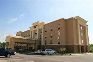 a large building with cars parked in a parking lot at Hampton Inn Defiance in Defiance