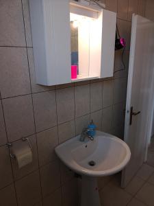 a bathroom with a sink and a medicine cabinet at David in 5 in Primošten