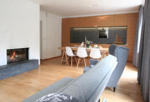 a living room with a table and a fireplace at Village House in Železniki