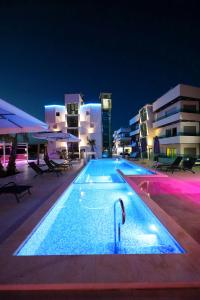 a large swimming pool at night with buildings at Boutique Residence Cosmopolis in Bibinje