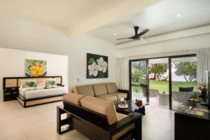a living room with a couch and a bed at Lomani Island Resort &ndash; Adults Only in Malolo Lailai