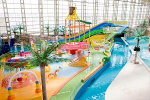 a water park with a pool and a water slide at Spa World HOTEL&RESORT in Osaka