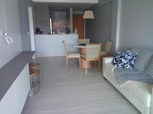 a living room with a couch and a table at Condomínio Polinésia in Porto De Galinhas