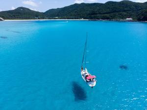 a boat in the middle of a large body of water at Kerama Terrace in Tokashiki