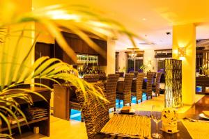 a restaurant with tables and chairs and a bar at Kerama Terrace in Tokashiki