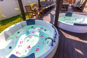 a jacuzzi tub on a deck with a table at Kerama Terrace in Tokashiki