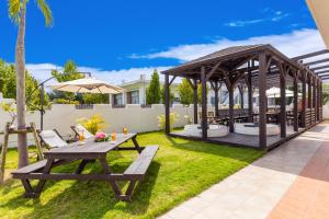 a backyard with a picnic table and a gazebo at Kerama Terrace in Tokashiki