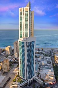 a city with two tall buildings next to the ocean at Holiday Holiday H-Residences Apartments in Gold Coast