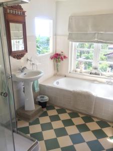 a bathroom with a tub and a sink at Pondok Plantation Luxury Mountain Escape Bedugul in Bedugul