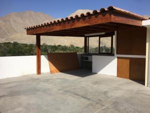 a patio with a roof on top of a building at LA CASA BLANCA in Lunahuaná