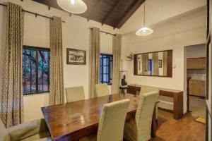a dining room with a wooden table and chairs at Villa Republic Bandarawela (04 bedroom) in Bandarawela