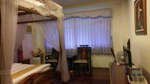 Rúm í herbergi á Emoonten Homestay