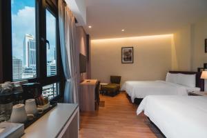 Postel nebo postele na pokoji v ubytování MPalace Hotel KL