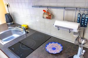 a kitchen counter top with a sink and a sink at Apartment Leon and Leona in Opatija