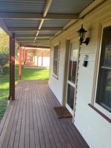a front porch of a house with a wooden deck at Dunkeld Studio Accommodation in Dunkeld