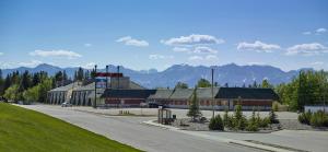 a building on a street with mountains in the background at Crestwood Hotel in Hinton