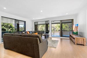 a living room with a couch and a tv at Bonville on Bonville in Sawtell