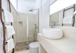 a white bathroom with a sink and a shower at Finca El Idilio in Ses Salines