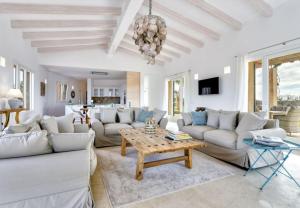 a living room with white couches and a table at Finca El Idilio in Ses Salines