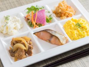 a white plate with different types of food on it at Super Hotel Anan Tomioka in Anan