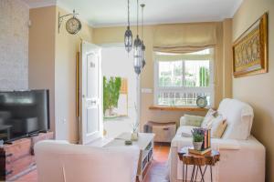 a living room with a couch and a tv at El Rinconcito de la Azohía in La Azohía