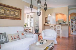 a living room with a white couch and a table at El Rinconcito de la Azohía in La Azohía