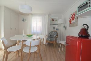 a kitchen and dining room with a table and a red refrigerator at Haus Wiedersehen, Mischabel (2-Zi) in Saas-Grund