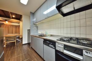 a kitchen with a stove and a counter top at Comfortable House In Fushimi 2 in Kyoto