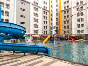 a pool of water with a playground in a building at 2BR Apartment at 18th Floor Great Western By Travelio in Tangerang