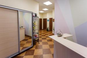 an office hallway with a glass door and a tile floor at Re Hostel in Novosibirsk