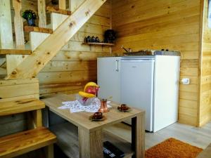 a small kitchen with a refrigerator and a table at Timber House in Tivat