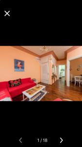 a living room with a red couch and a table at Villa Barchelona in Kallirákhi