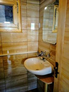 a bathroom with a sink and a mirror at Timber House in Tivat