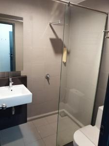 a bathroom with a shower and a sink at T+ Hotel Sungai Korok in Alor Setar