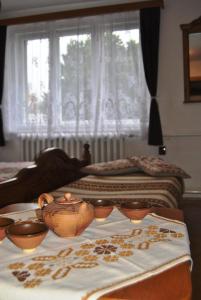a bedroom with two beds and a table with bowls on it at Ohrazenice 103 in Turnov