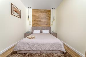 a bedroom with a bed with a wooden headboard at Odessarooms sea view in Odesa