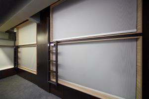 a sliding garage door in a room with windows at The Pod at Beach Road Boutique Capsule Hotel in Singapore